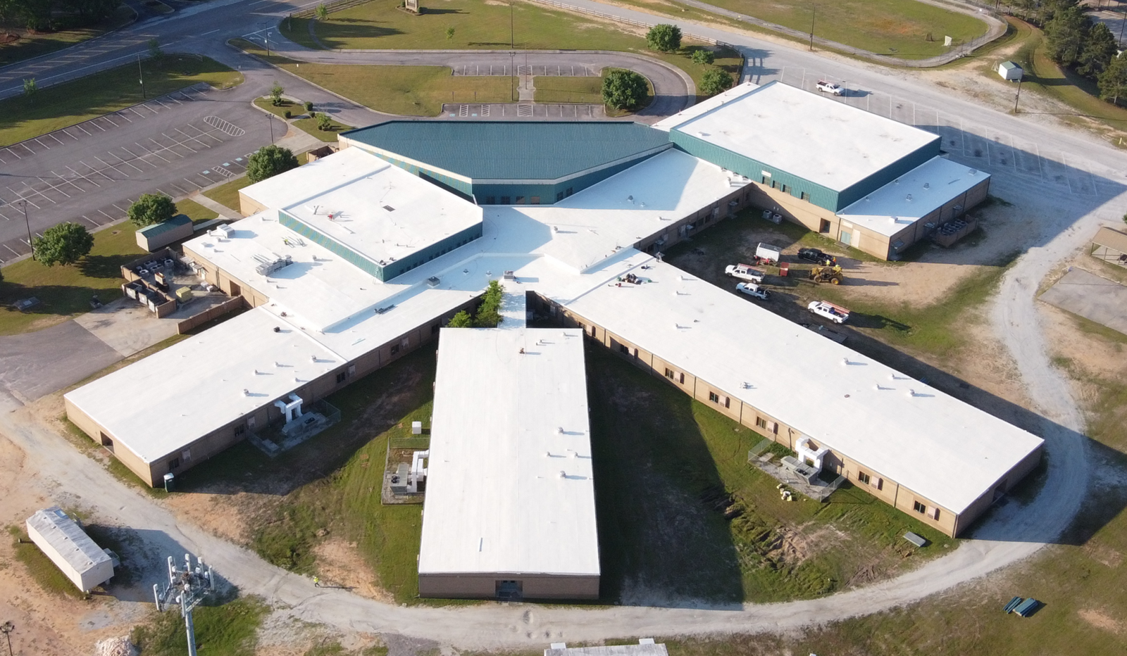 Aerial of a school campus re-roof with single-ply membrane and standing-seam metal by RPI Roofing in Columbia, SC