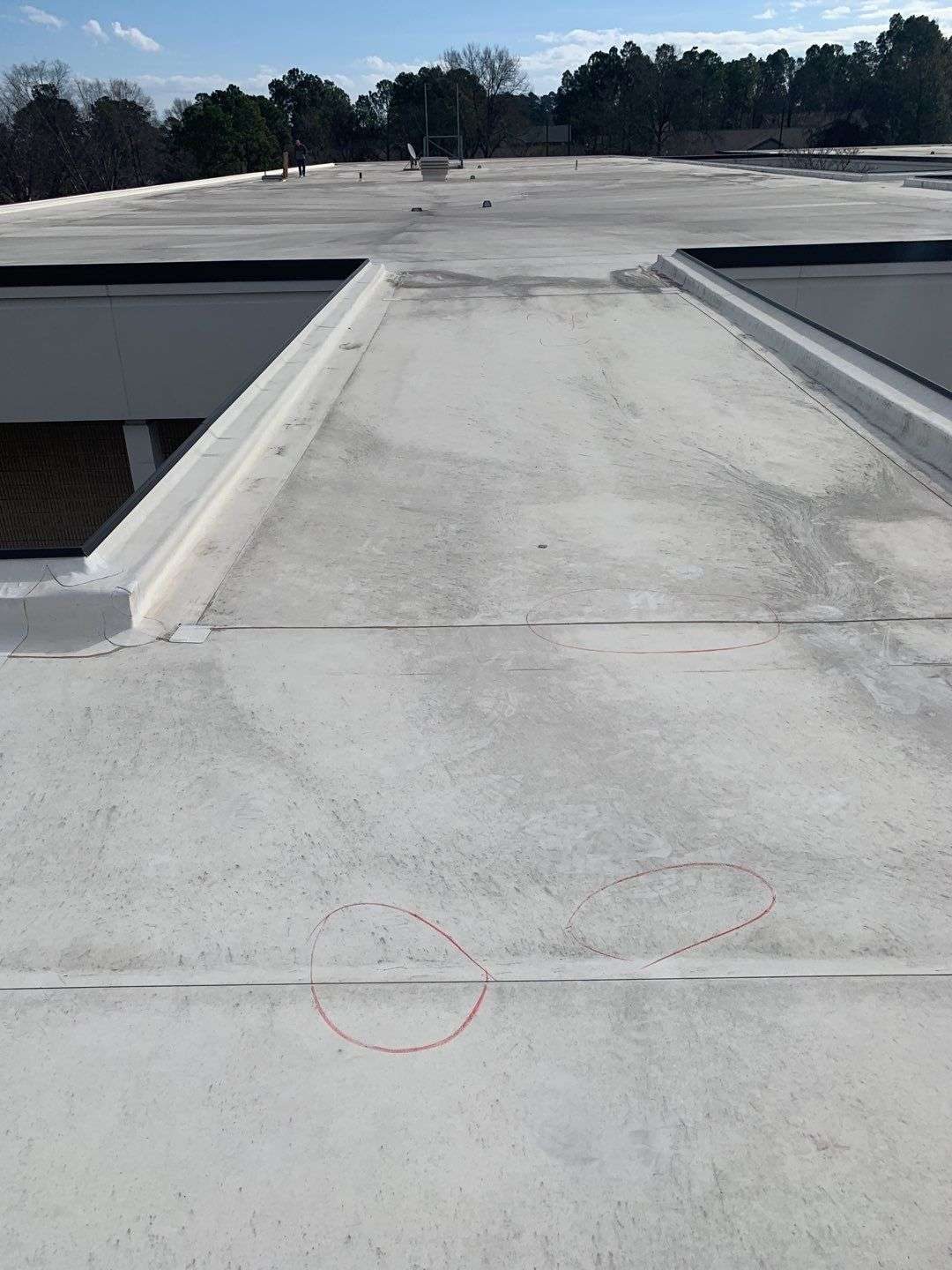 White single-ply commercial membrane marked up during an RPI Roofing restoration assessment